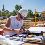 Construction worker reviews the site plans